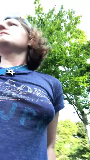 Voluptuous temptress plays with her natural, awesome tits and furry pussy in a churchyard