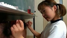 Standing behind the blackboard dude gets a nice handjob performed by cutie