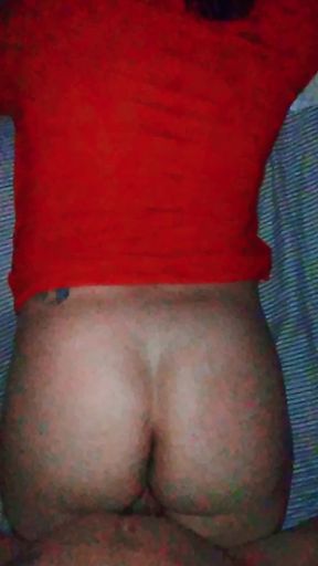 The woman in red receives a strong and powerful thrust and twerks in response to the bull.