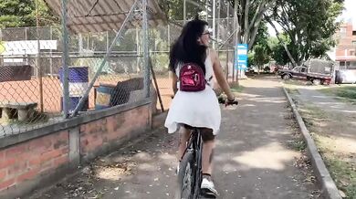 Brunette Latina rides dildo while clinging to bike handlebars leans back screaming squirting orgasm pleasured by glasses and tattoos.