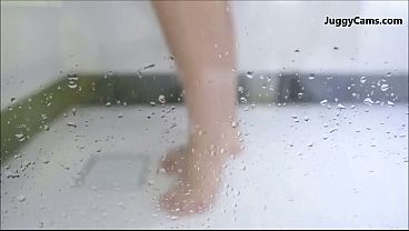 Big-boobed babe gets wet and wild in a shower cam scene