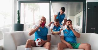 Sporty dudes getting off while watching the game
