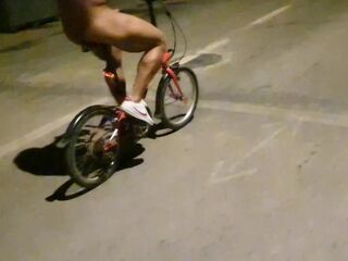 Hot chap disrobes on a public street and rides a bike nude touching his weenie - risky