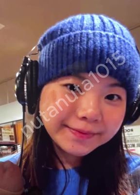 Headphones and blue beanie