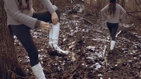 Walking in white boots on a frozen muddy road