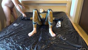 Latex Danielle is attached to the bed and masturbated with the massage vibrator