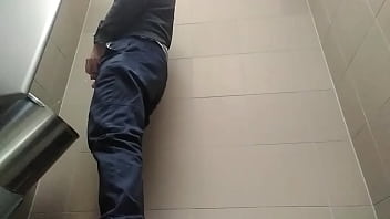 Young guy peeing with his uncut cock in a highway toilet