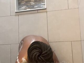 Black washing her large soapy breasts and charming cunt in Miami