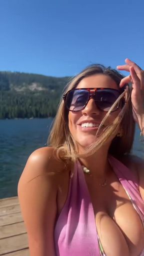 Big-titted brunette in a bikini at the lake