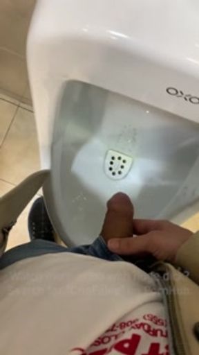 Jerk off a guy's dick in a public toilet. risky