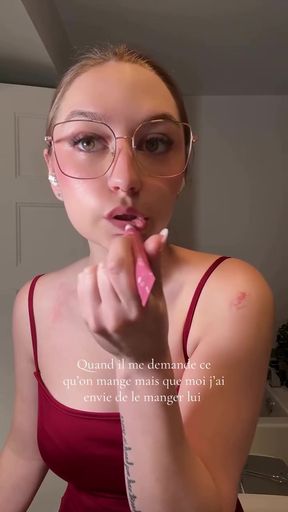 Woman in red dress blowing bubble gum