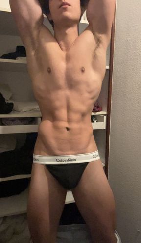 Young bodybuilder posing in a tight thong