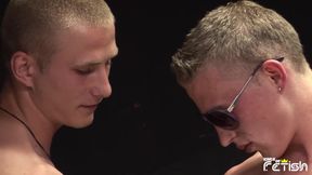 Muscular guy with sun glasses and his friend blow each other with passion