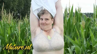 Hairy mature BBW Tina fingers her fat pussy and plays with her huge ass in a corn field