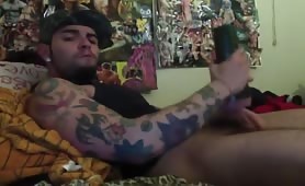 Handsome tattooed guy strokes his cock using his new toy