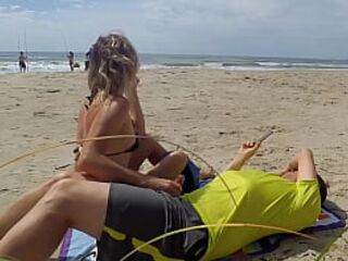 Milf makes stranger ejaculate with skillful handjob right on the beach