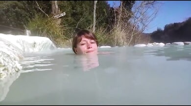 Young brunette basks nude in the natural thermal pools of Petriolo, Tuscany