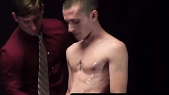 Muscular older man fingers and barebacks younger apprentice on exam table