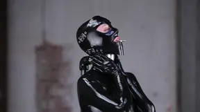 Glossy black latex gimp suit baddie teasing tongue out for hardcore fetish play