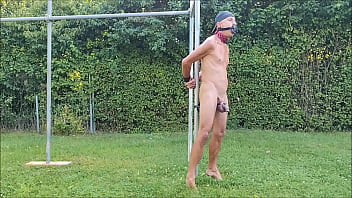 naked pathetic slave in penis cage during outdoor party tied up with dildo in ass, peeing