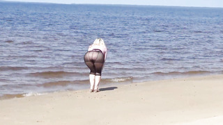 Jokey cougar with nylon caboose and breasts on beach