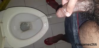 Horny guy pissing in the toilet