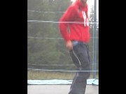 Teen shows his big cock for fun on a trampoline at the camp