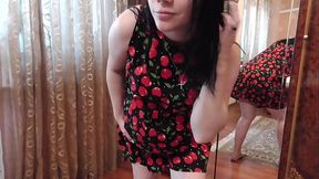 Beautiful pregnant Anna tries on a dress near the mirror