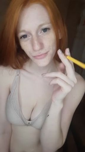 redhead girl smokes a cigarette