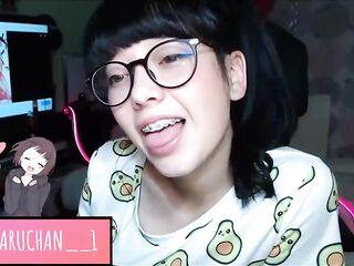 Excited teen with braces and glasses is showing her tongue on web camera, late at night
