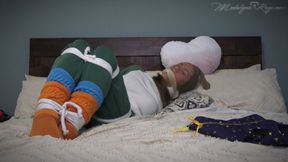 AJ Silences Madalynn During The Slumber Party Movie 4K- Sweatpants & slouch sock wearing AJ ties up and gags Madalynn because she can't keep quiet, AJ changes her gag and pantyhose hoods Madalynn leaving her to struggle