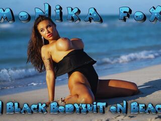 Hot Monika Fox in Ebony Bodysuit on Beach