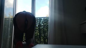 In Lingerie and Heels at the Window with a Toy