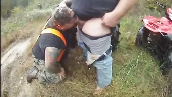 Chubby bear gets a blowjob in the rain outdoors