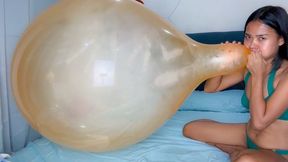 Sexy Camylle Blows To Pop Yoiur Huge Orange Belbal 24 Inch Balloon In A Green Bikini