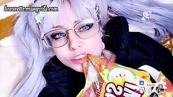 Cute blonde teen girl eats chili gummy worms with pig tails and glasses