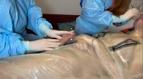 Miss Nastya and Miss Camilly do a dental check up while simultaneously giving a handjob to their rubber gimp with transparent surgical gloves