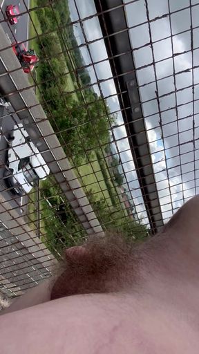 Naked above highway. Caught by cars