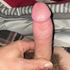 Slowly stroking uncut cock close up