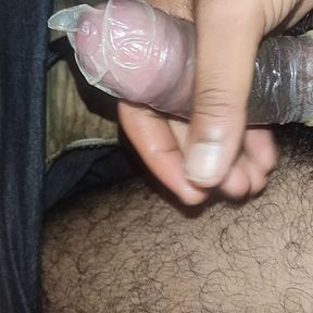 Masturbating wearing condom