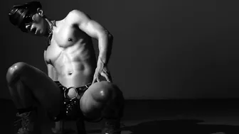 Muscular jock in chastity cage straps on huge dildo and strokes slowly