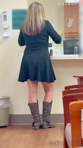 Woman in black dress at counter