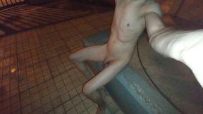 Nude in public playing with piss