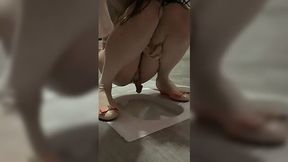 Excited Asian ladyboy jerks off her hard cock in public toilet