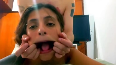Tattooed brunette gives a deep blowjob while fingering herself on webcam