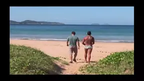 Sexy Brazilian babe strips nude on beach, flaunting flawless figure.