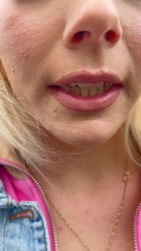 A rollerblade blondie girl is littering and smoking and spitting loogies while smoking a cigarillo