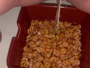Girl pees in a bowl of cereal