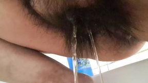 she urinates and washes her vulva &mdash;  the water trickles down her clit &mdash;  turning her on