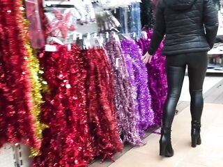 Amateur gal with leather leggings searching for a flawless Christmas tree